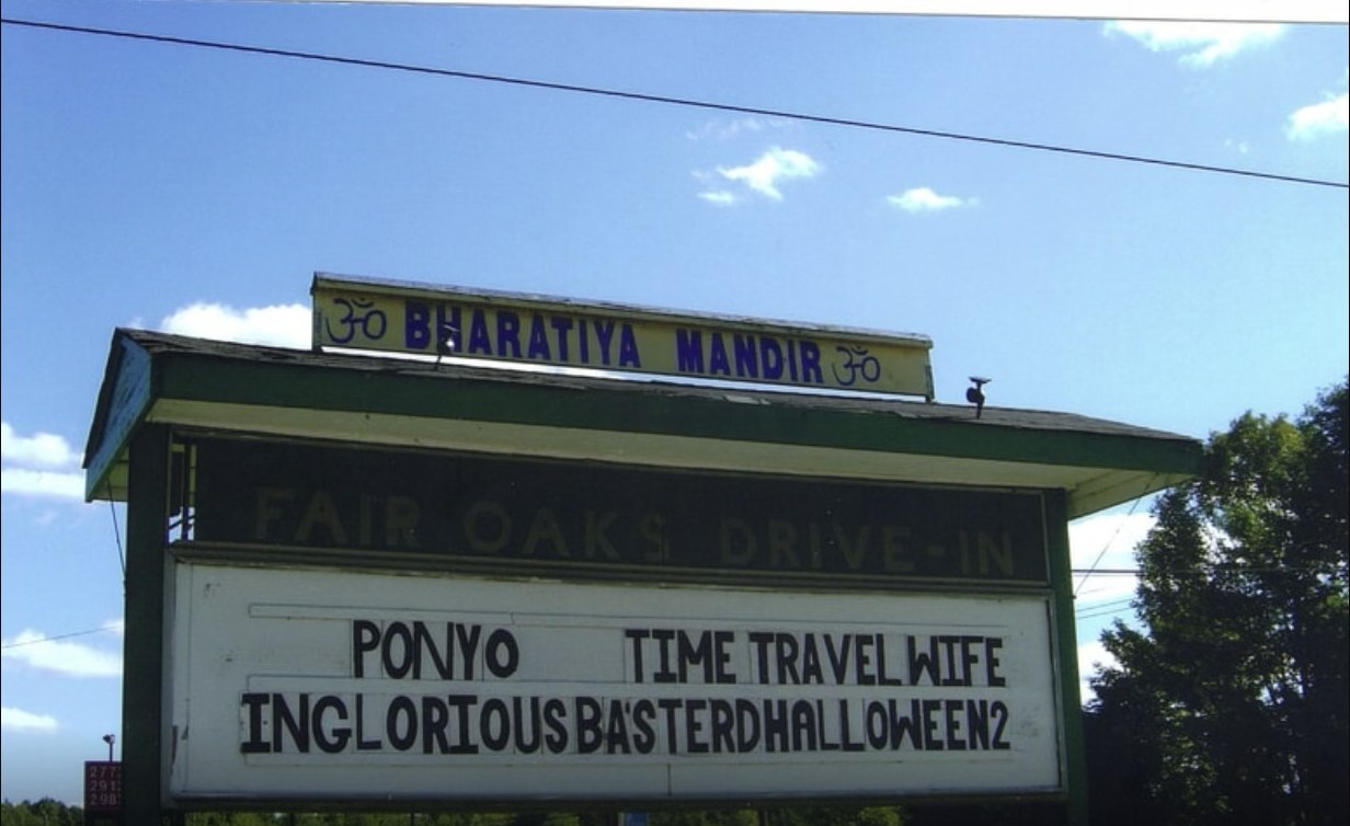 The Fair Oaks Drive-In roadside marquee sign listing the night's features.